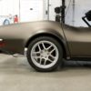 bronze corvette with chrome tires and smooth floor