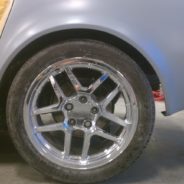 A 1968-1973 CORVETTE REAR FENDERS - 2" FLARE with a yellow rim and a yellow tire.