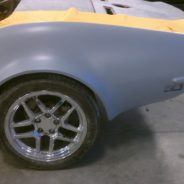 1968-1973 CORVETTE REAR FENDERS - 2" FLARE are being painted in a garage.