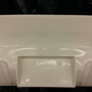 A white plastic 1968-1982 CORVETTE REAR TAILLAMP PANEL - GRAFT ON for a corvette.