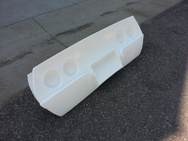 A white plastic 1968-1982 CORVETTE REAR TAILLAMP PANEL - GRAFT ON on the side of a street.