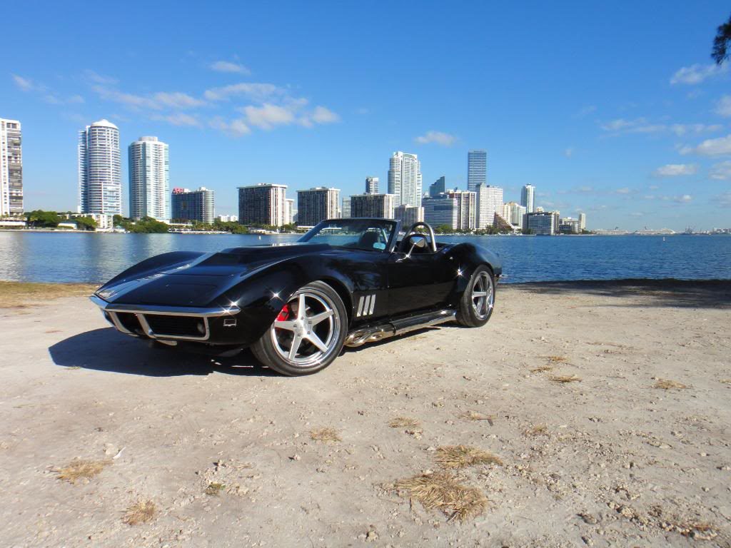 black corvette parked on a beach 3