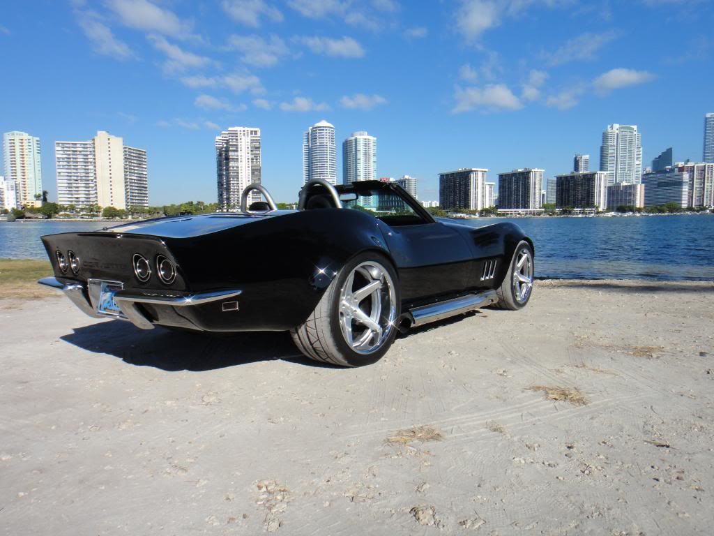 black corvette parked on a beach 9