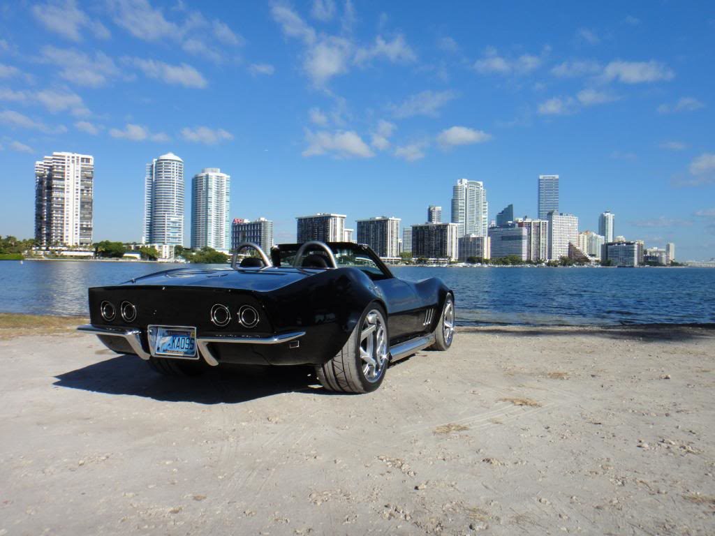 black corvette parked on a beach 8