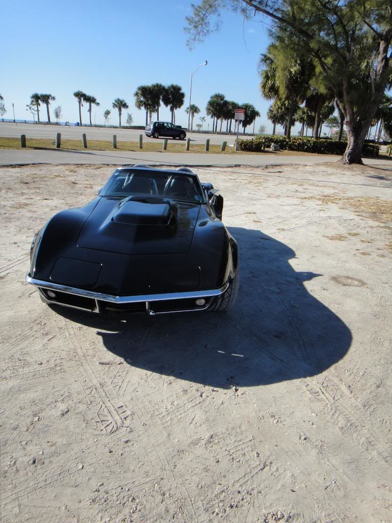 black corvette parked on a beach 14