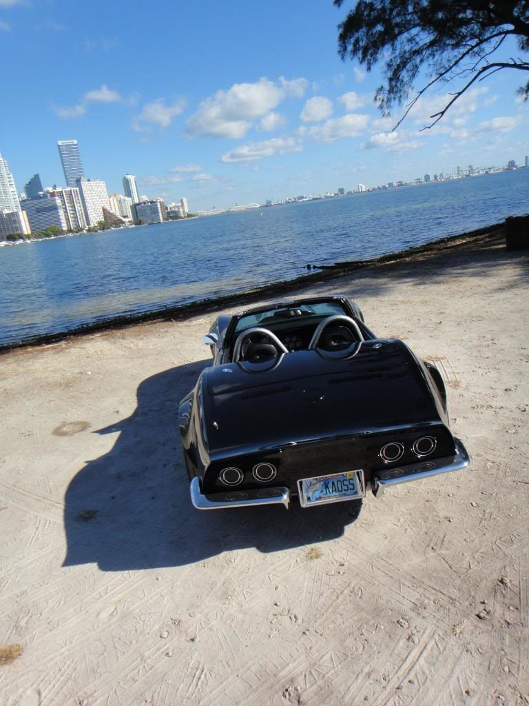 black corvette parked on a beach 13