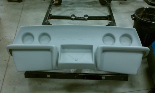 A gray plastic 1974-1982 REAR BUMPER - CHROME BUMPER LOOK tray with four holes on it.