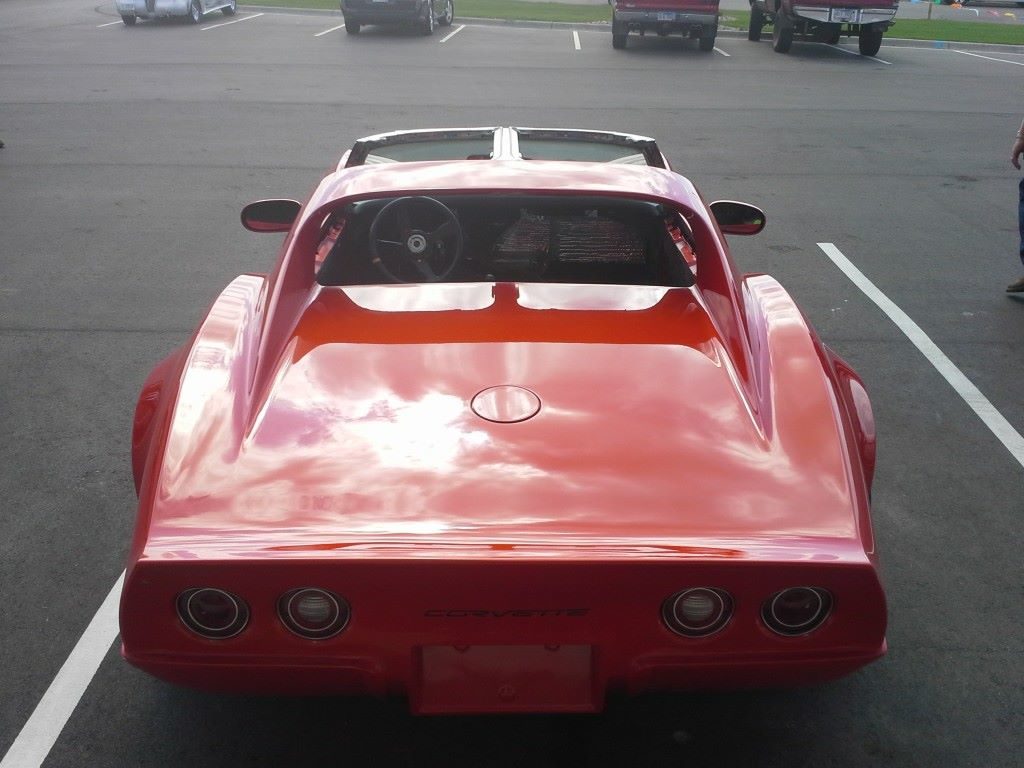 A red sports car parked in a parking lot.