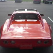 A red sports car parked in a parking lot.