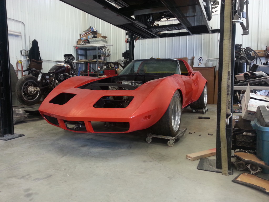 A red color corvette car at a garage