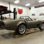 A brown corvette sitting in a garage.