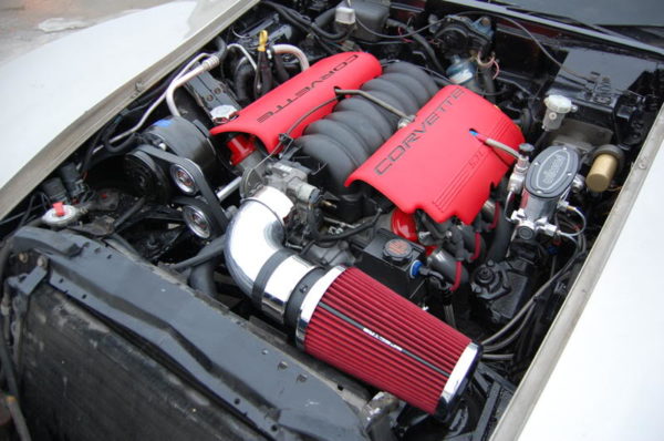 The engine compartment of a car with LS1 SWAP AC BRACKETS FOR THE R4 COMPRESSOR.