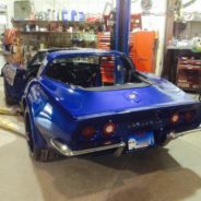 A blue 1974-1982 Corvette Chrome Bumper Conversion Kit - Stock Rear Fenders sitting in a garage.