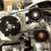 A car engine with LS1 SWAP AC BRAKETS FOR THE SANDEN COMPRESSOR attached to it.