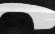 A black and white photograph of a white car.