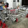 A SRIII 1963-1982 ROUND TUBE FRAME is being built in a garage.