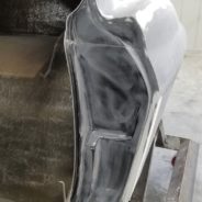 A 1963-1967 Corvette Replica Coupe is being molded in a factory.