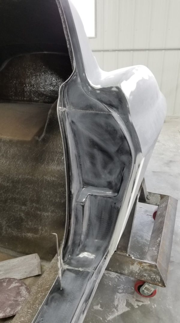 A 1963-1967 Corvette Replica Coupe is being molded in a factory.