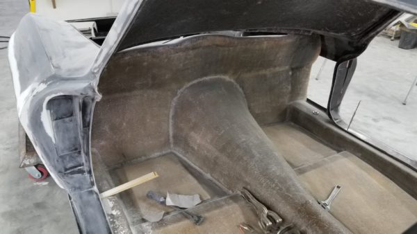 The interior of a 1963-1967 Corvette Replica Coupe is being worked on.