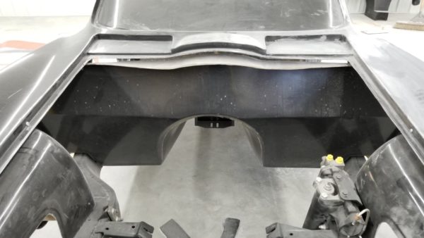 The rear end of a 1963-1967 Corvette Replica Coupe in a garage.