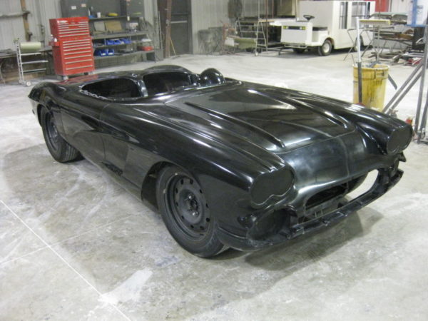 A 1962 Corvette Replica Roadster is sitting in a garage.