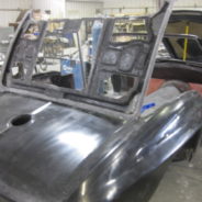 A 1967 Corvette Replica Roadster is being worked on in a garage.