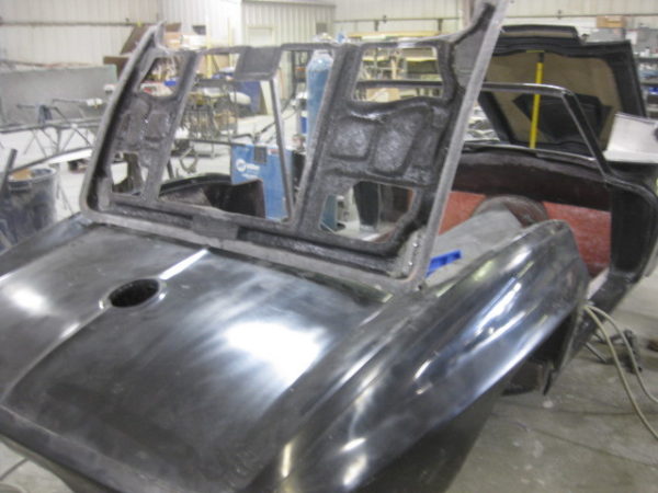 A 1967 Corvette Replica Roadster is being worked on in a garage.