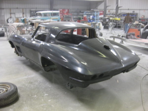 A 1963-1967 Corvette Replica Coupe sitting in a garage.