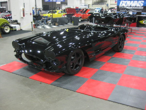 A 1962 Corvette Replica Roadster black and white checkered floor.