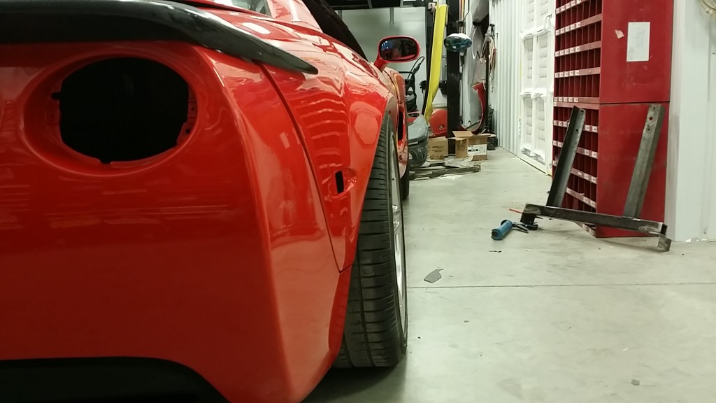 A red sports car in a garage.