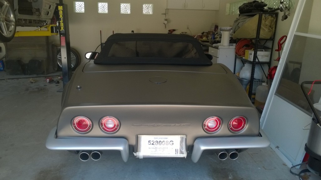 gray corvette with black top in full garage 2