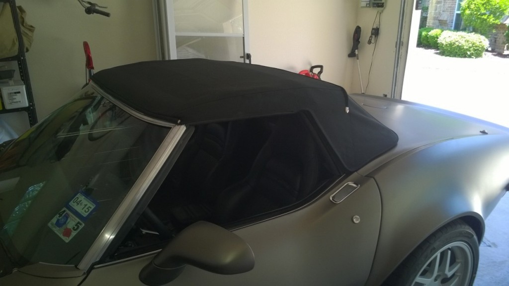 gray corvette with black top in full garage 4