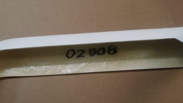 A white piece of plastic with a number on it would be the 1968-1973 REAR BUMPERS - FIBERGLASS.
