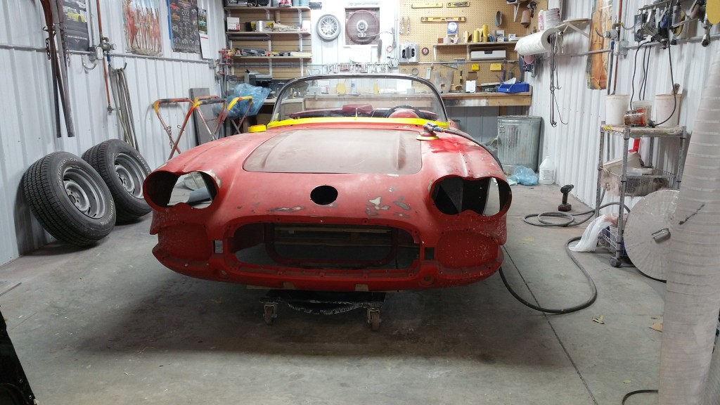 Speedvette yes color car parked at a repair shop