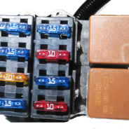 A '97 - '04 LS1 W/ T56 STANDALONE WIRING HARNESS (DBW) fuse box with several different colored wires.