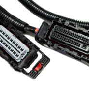 A pair of '08 - '09 L76 (6.0L) STANDALONE WIRING HARNESS W/6L80E connected to a car.