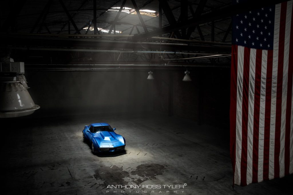 garage with American flag with blue corvette