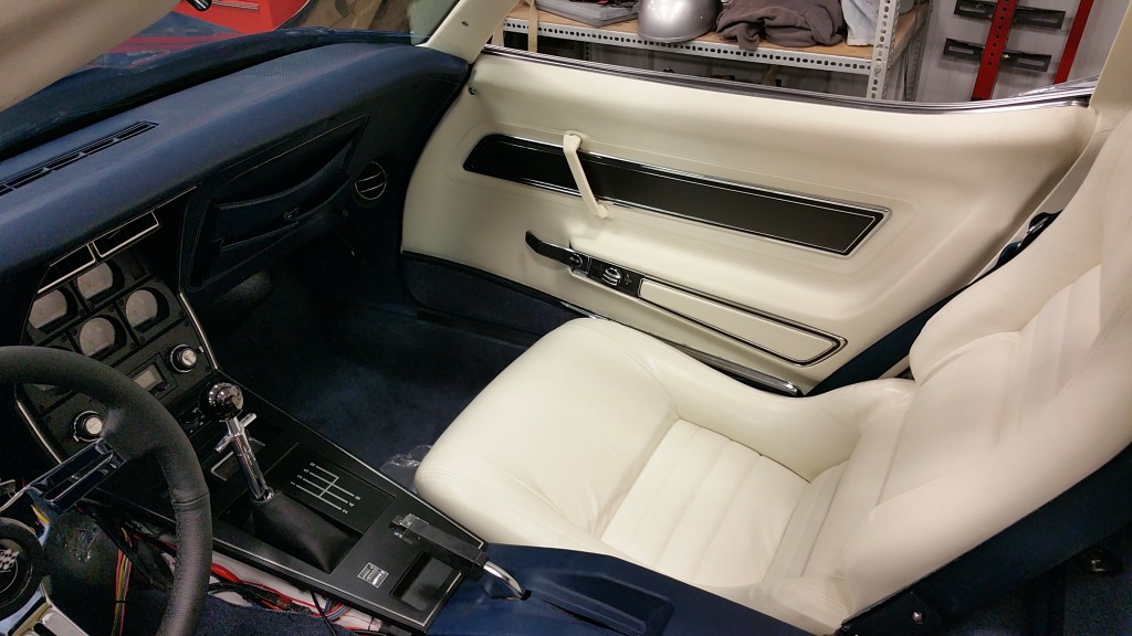 The interior of a sports car is white and blue.