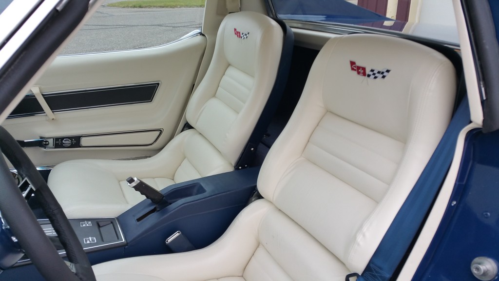 The interior of a blue sports car with leather seats.