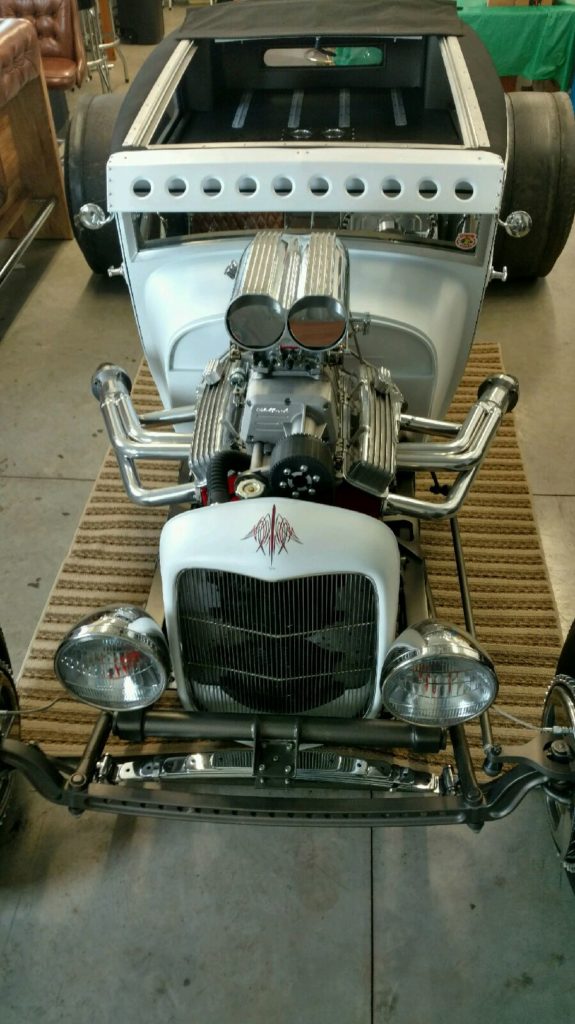 A white hot rod with a big engine.
