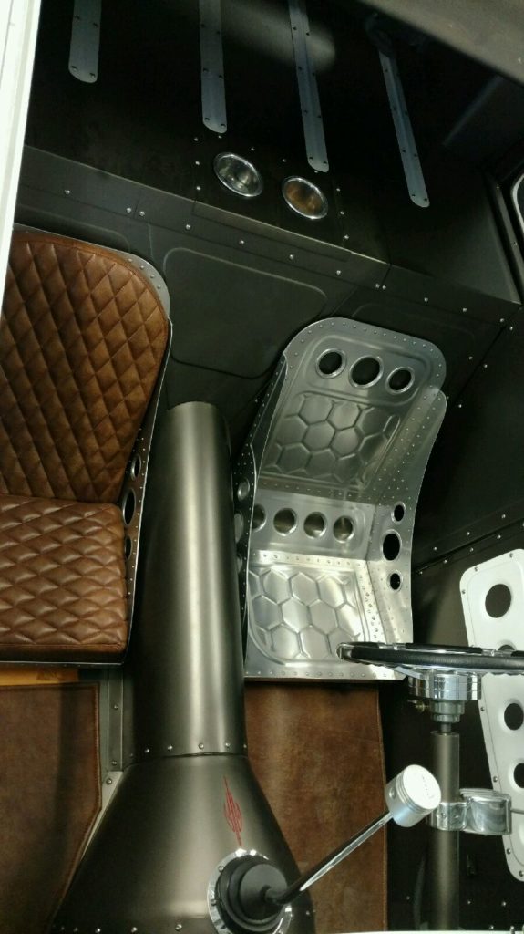 The interior of a car with a seat and a steering wheel.