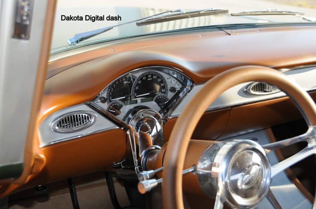 The interior of a classic car with a steering wheel and steering wheel.
