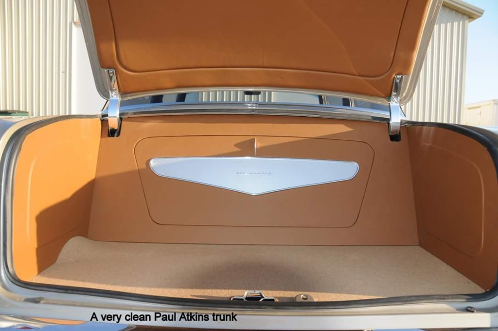 The trunk of a car with the trunk open.