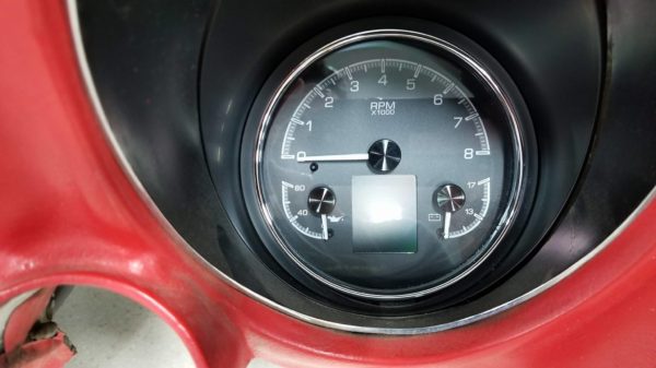 The dashboard of a red car with Dakota Digital HDX 3-1 Gauges.