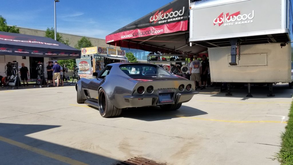 Chevrolet corvette parked in front of a truck.