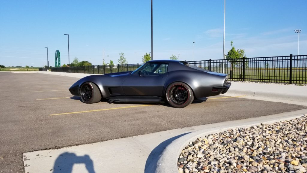 A black sports car parked in a parking lot.