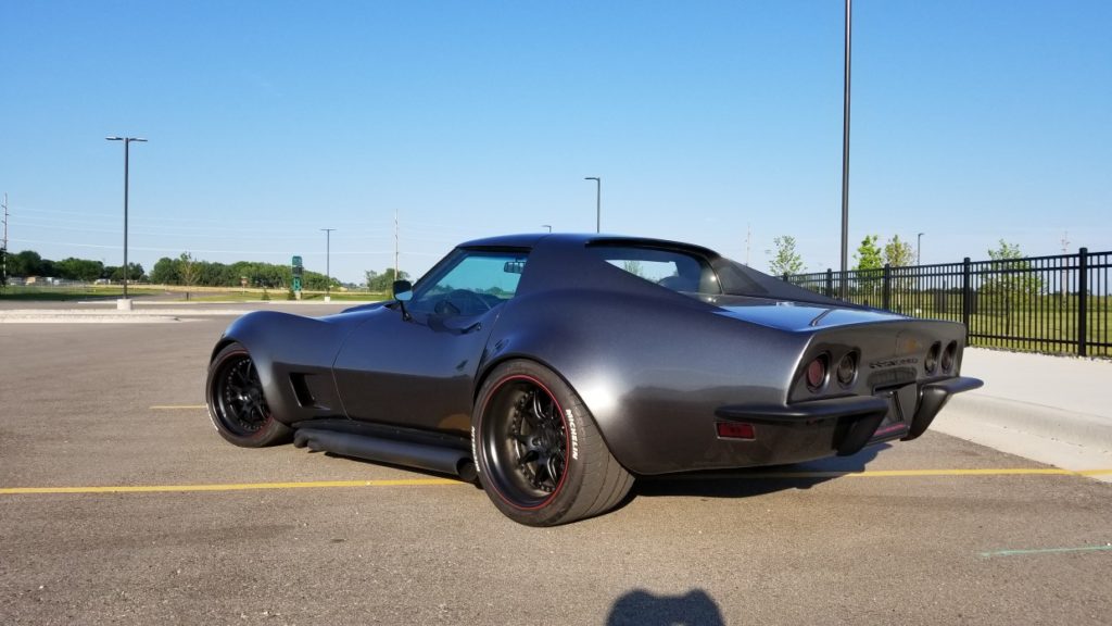A black sports car parked in a parking lot.