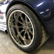 A close up of the rims of a blue car.