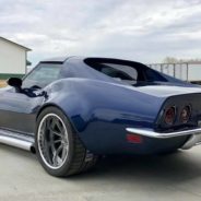 A blue chevrolet corvette parked in a parking lot.