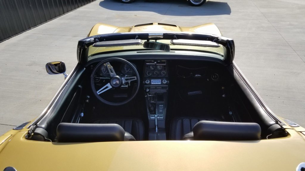 The interior of a yellow sports car.
